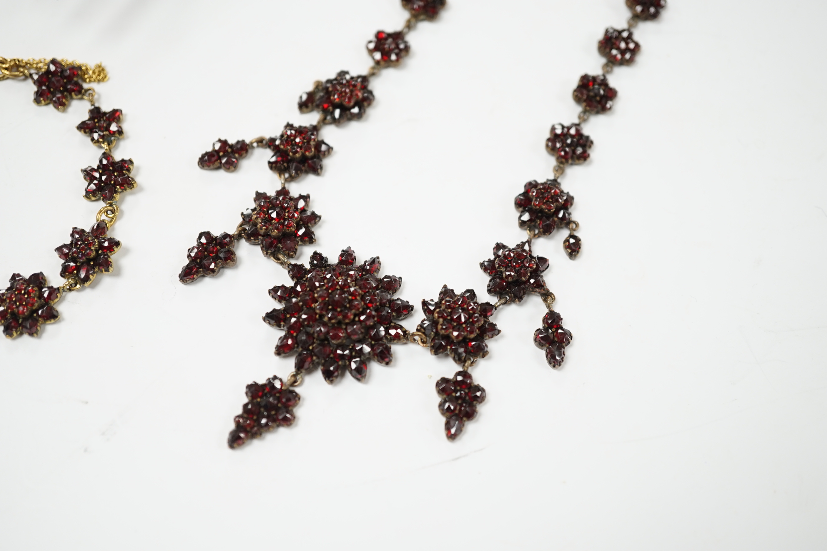 A Victorian garnet set gilt metal and tortoiseshell suite of jewellery comprising bracelet, necklace, ring and two hair combs